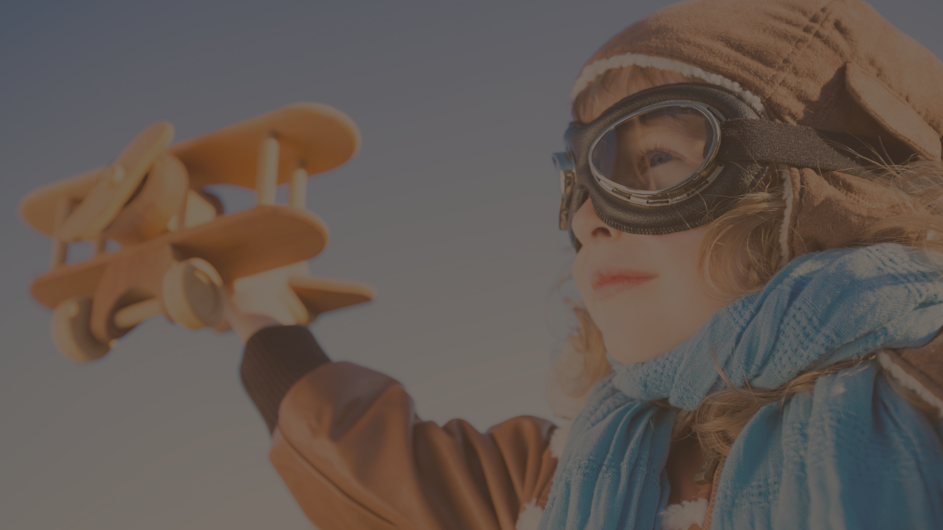 Child enjoying imaginative play with wooden airplane at BKMCC Childcare in Delta BC