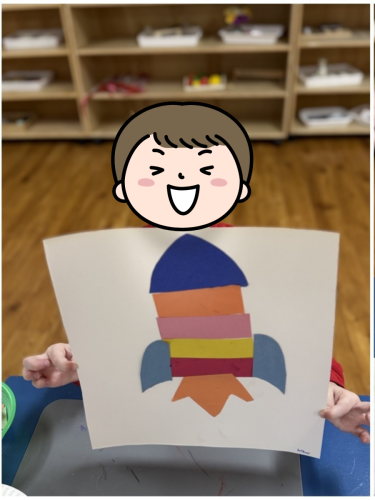 Childcare student in North Delta showing a colourful rocket art project at BKMCC.