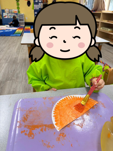 Childcare student painting orange Diya art during Diwali celebration in North Delta.