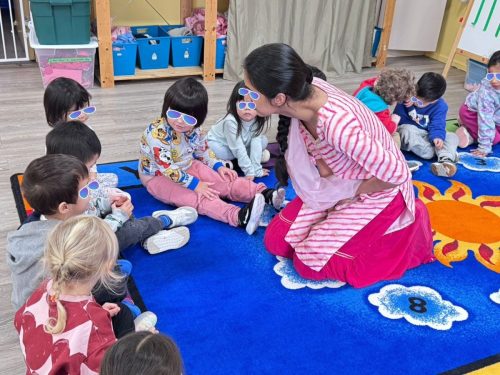 Children talking with teacher during Diwali activity at BKMCC North Delta