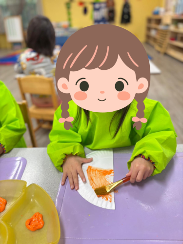 Childcare student in North Delta painting during Diwali Diya craft activity.