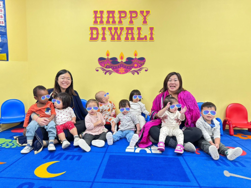 Smiling infants at North Delta childcare celebrate Diwali with their caring teachers.