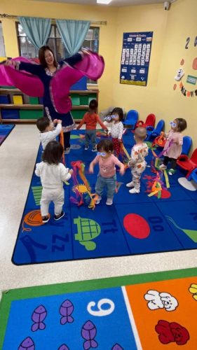Infants at BKMCC Childcare in North Delta dance joyfully during Diwali celebration.