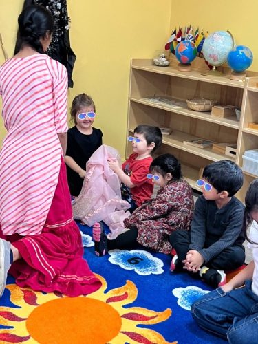 Children at North Delta childcare learn about Diwali traditions with their teacher.