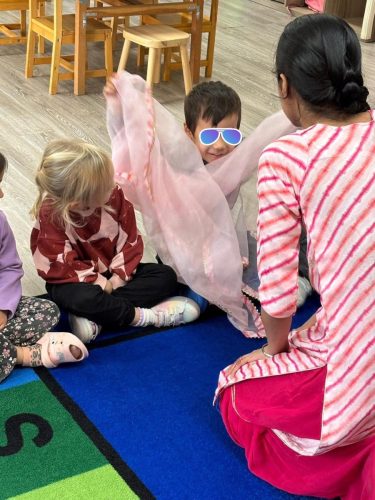 Children at BKMCC Childcare in North Delta explore Diwali with colourful fabric play.