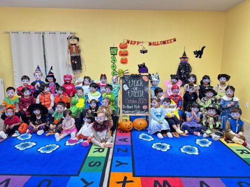 Children in costumes posing for Halloween class photo at BKMCC in North Delta.