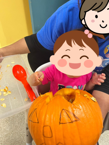 Infant enjoys pumpkin carving fun at BKMCC Childcare in North Delta.