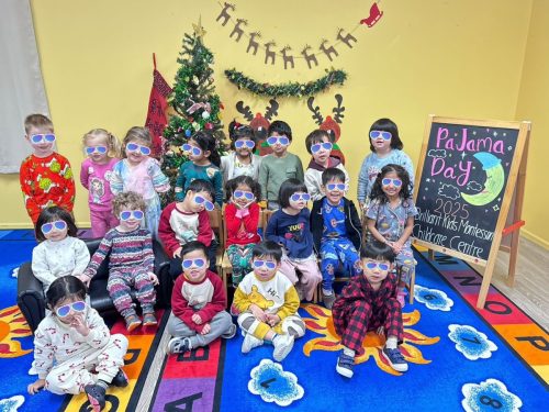 A group of children aged 3-5 sitting together in their pajamas for a fun classroom event at BKMCC.