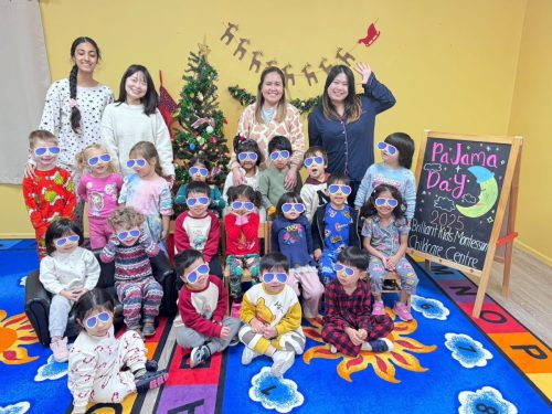 BKMCC teachers and children aged 3-5 smiling together during Pajama Day celebration.